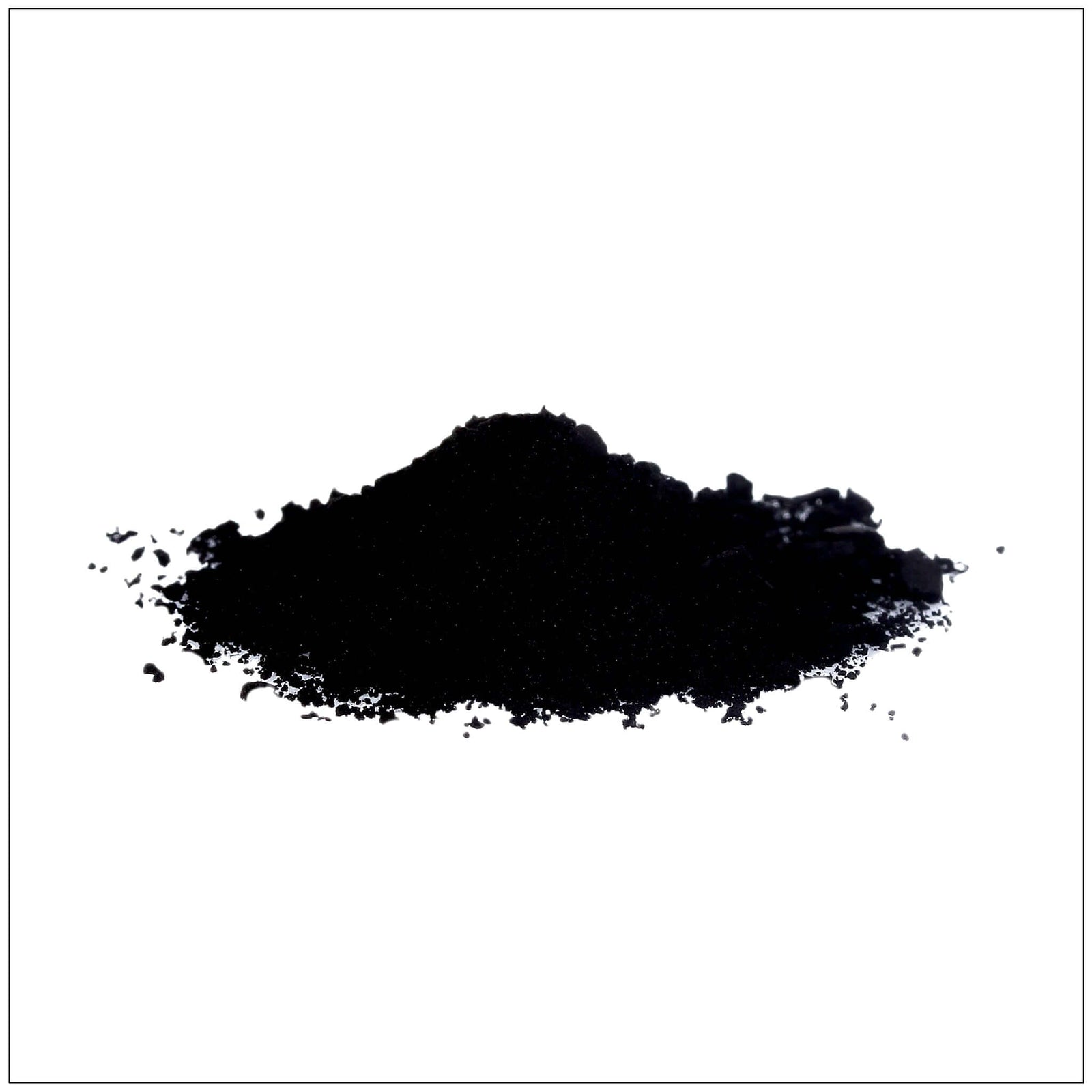 Fine black powder of activated charcoal in a wooden spoon with scattered granules on a white.