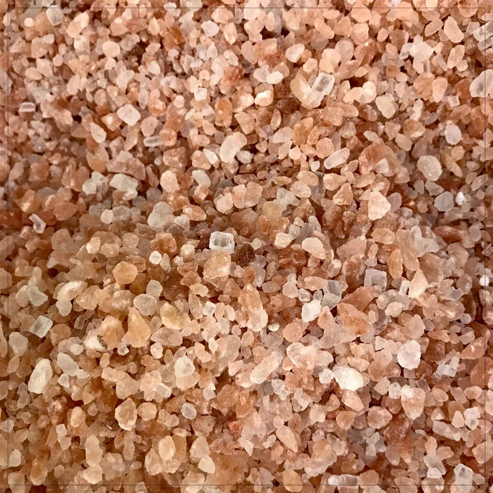 Pink Himalayan salt crystals in a rustic bowl