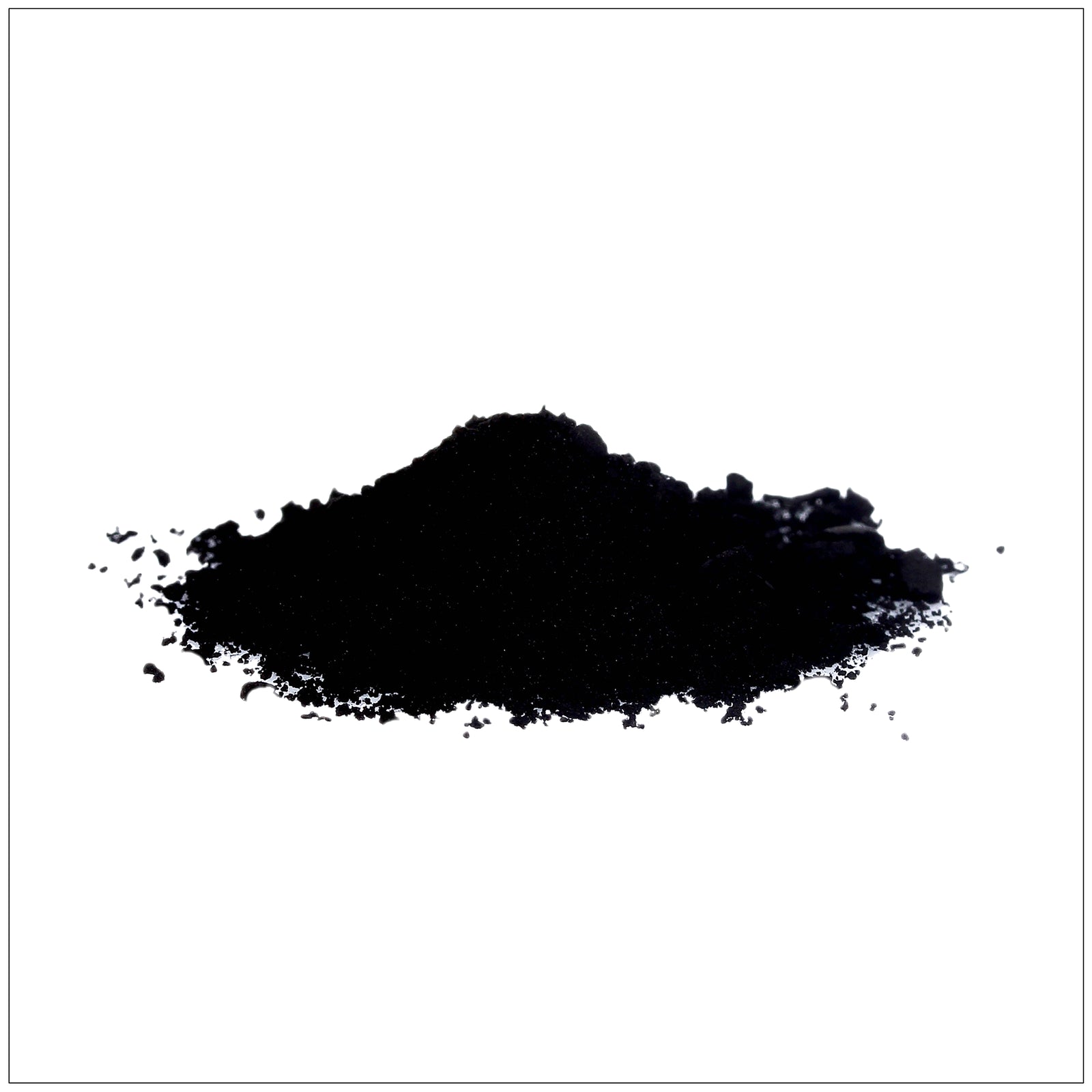 Fine black powder of activated charcoal in a wooden spoon with scattered granules on a white.