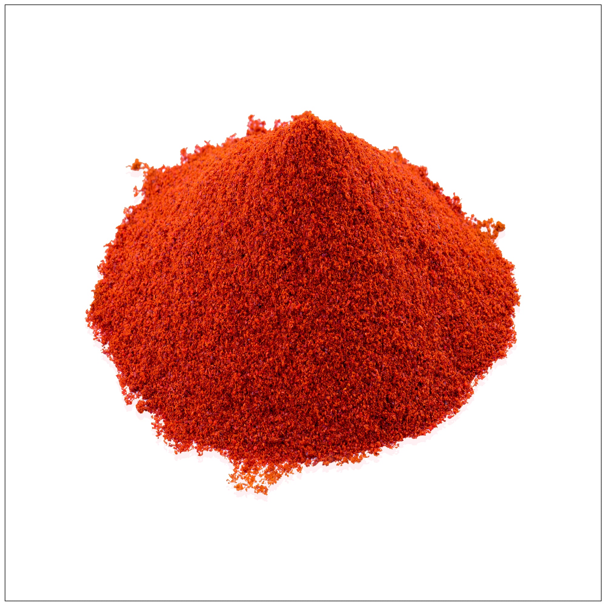 Close-up of vibrant red chili powder in a rustic wooden bowl on a kitchen counter.