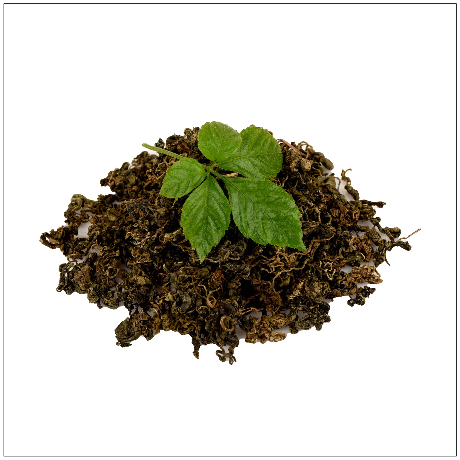 Cup of freshly brewed Gynostemma tea with loose leaves on a wooden table, promoting natural wellness.