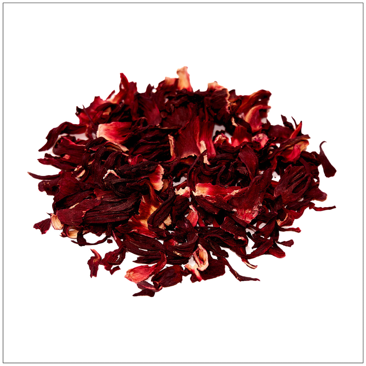 Refreshing hibiscus flower tea in a glass cup with vibrant red color and natural dried petals beside it.