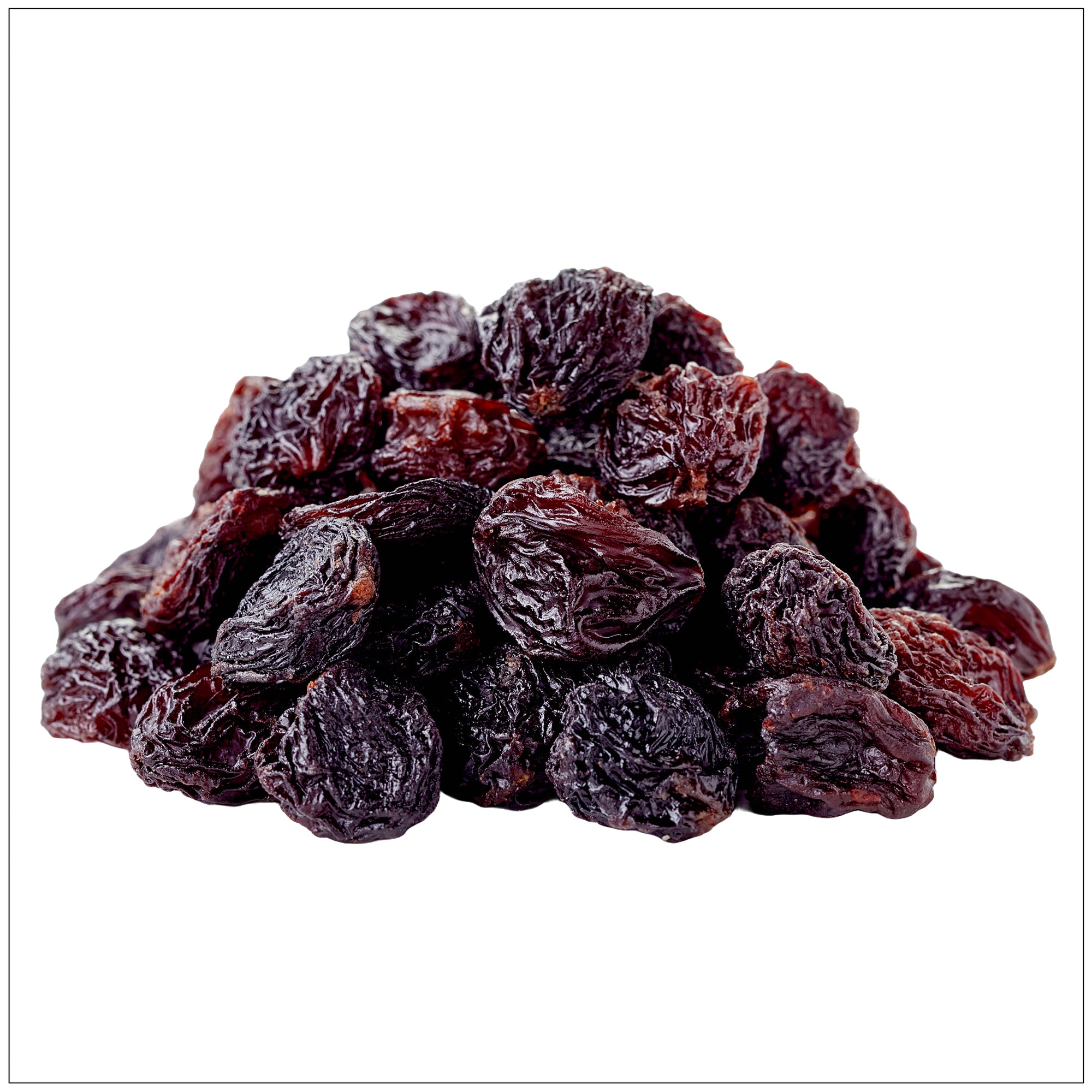 Close-up of jumbo black raisins with a wrinkled texture and deep, dark color, piled together.