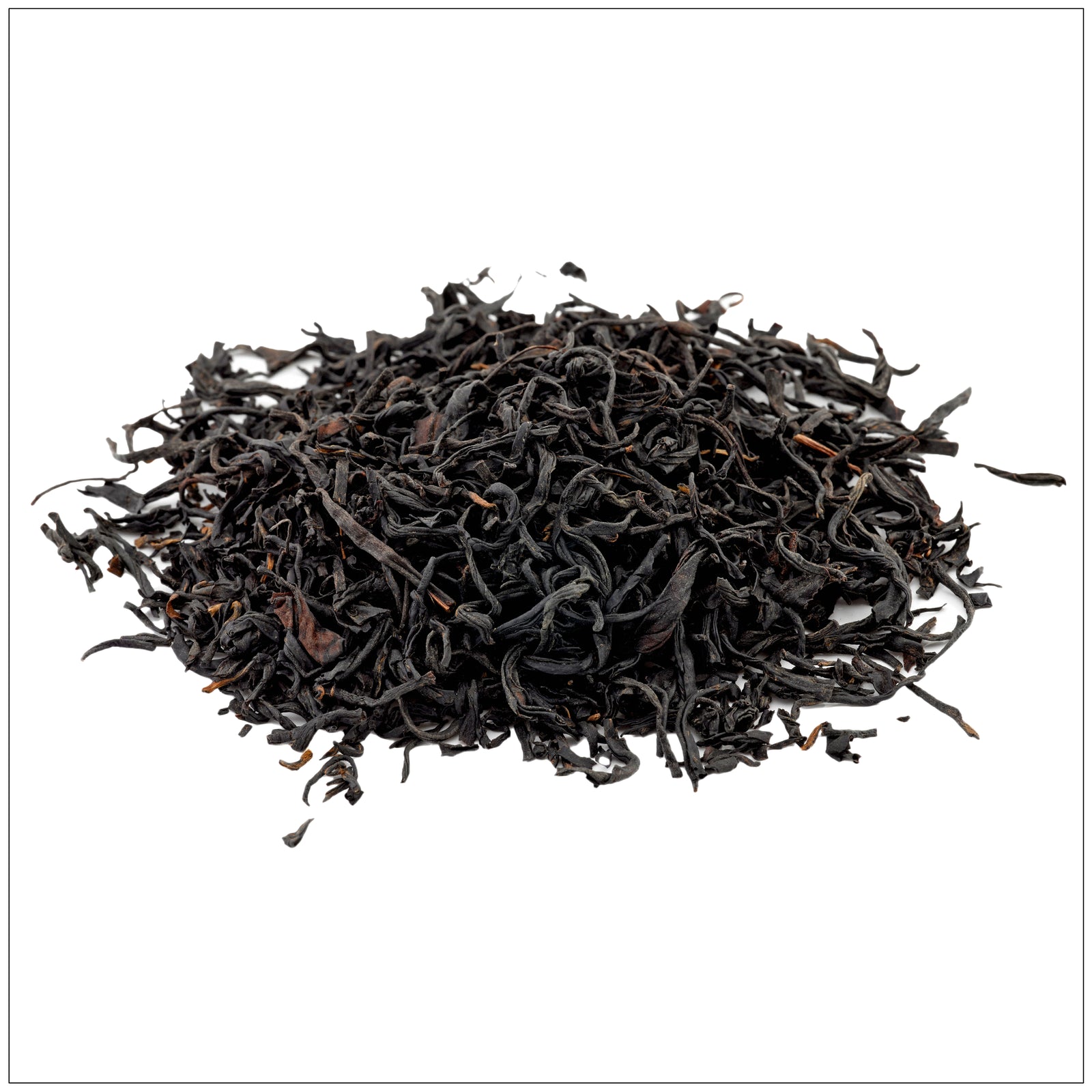 Smoky black Lapsang Souchong tea leaves in a ceramic cup with a rustic wood background.