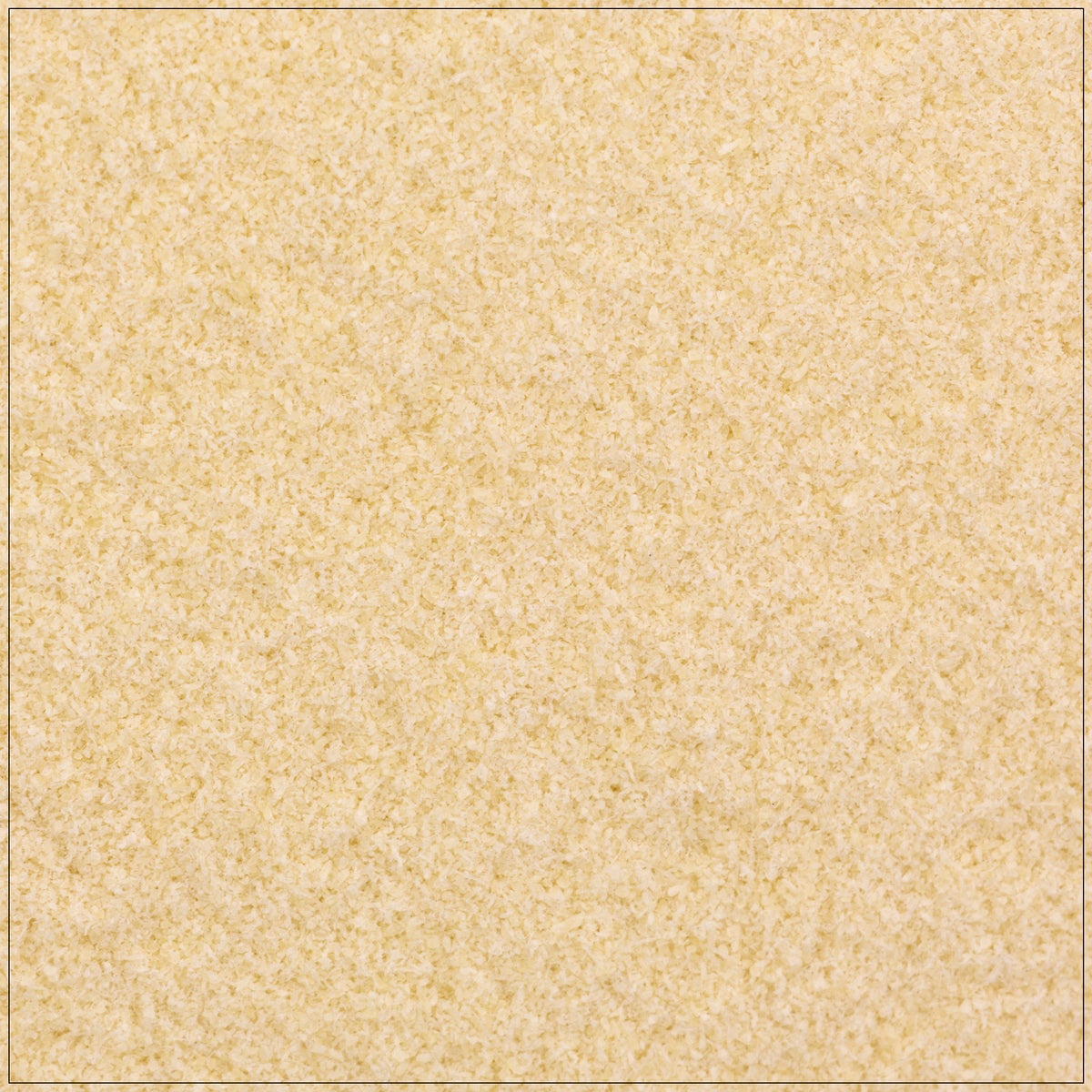 Fine white xanthan gum powder in a wooden spoon on a kitchen counter, used as a thickening agent in recipes.