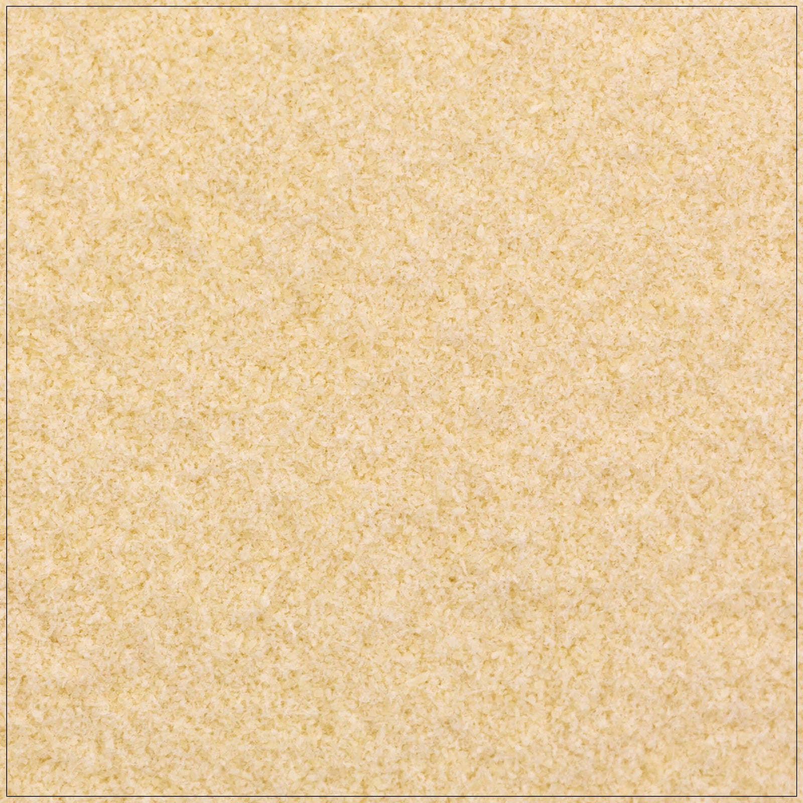 Fine white xanthan gum powder in a wooden spoon on a kitchen counter, used as a thickening agent in recipes.
