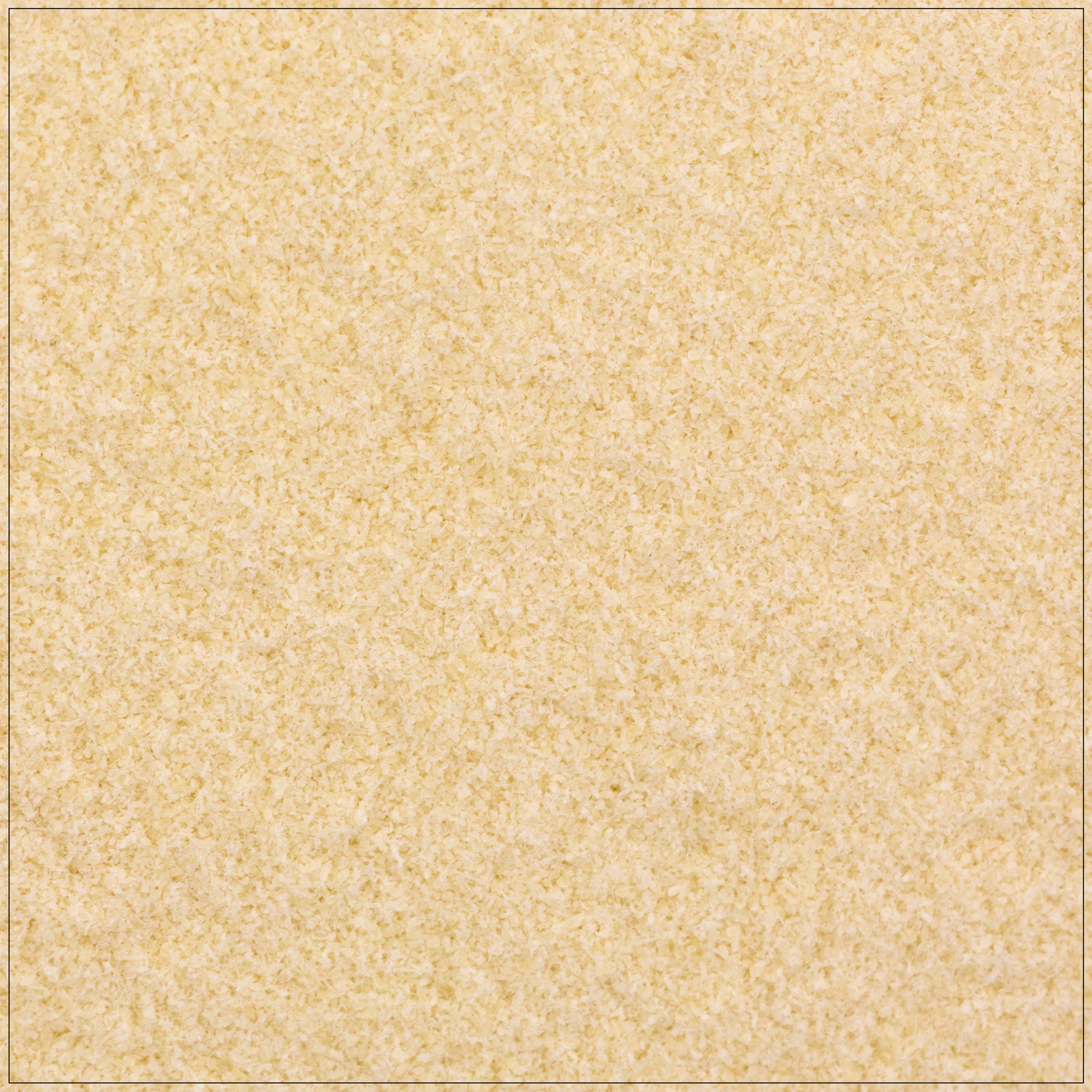 Fine white xanthan gum powder in a wooden spoon on a kitchen counter, used as a thickening agent in recipes.